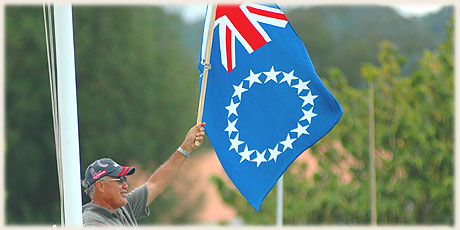 Ted Nia - holding up the national flag during Round Raro OC1 Relay Race / Photo by Lawrance Bailey © sokalavillas.com